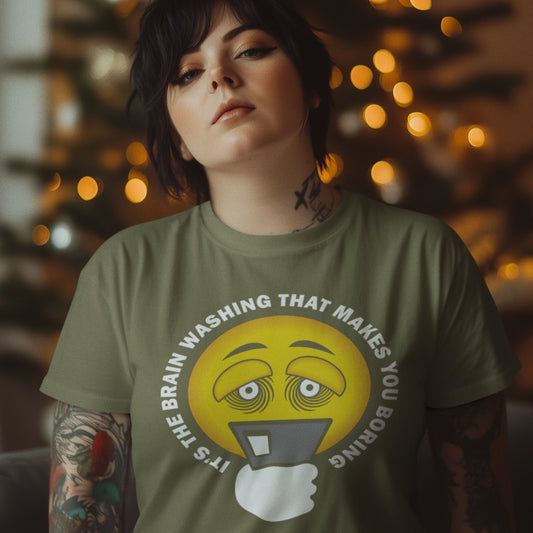 Person wearing a khaki t-shirt with a graphic design and text, against a blurred background with lights. This conspiracy theorist t shirt highlights the hypnotic obsession some people have with their phone and suggests a conspiracy theory of brain washing as a cause. Ideal for displaying that anti smart phone feeling. Made from 100% organic ring-spun cotton, this conspiracy theory t-shirt is unisex, high-quality, super comfy, and best of all, eco-friendly.