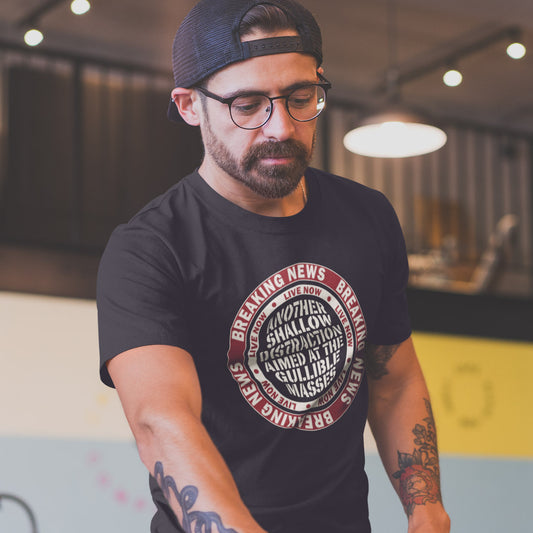 Man wearing a black t shirt. An anti media, non conformist t shirt. This design suggests that the media is being used to keep us distracted from the real issues taking place around us. Don't fall for the new bright flashing lights! Made from 100% organic ring-spun cotton, this social awareness t shirt is unisex, high-quality, super comfy, and best of all, eco-friendly.