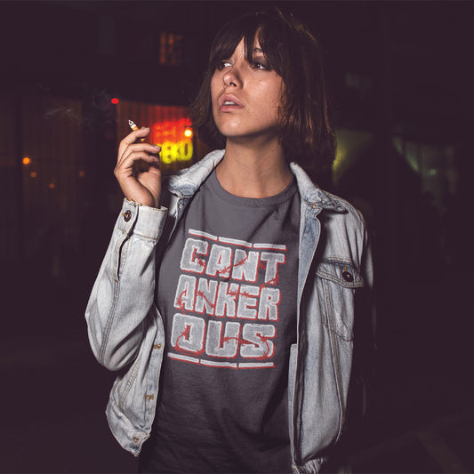 A woman smoking in the street, wearing an anthracite grey t-shirt with a "CANTANKEROUS" logo.