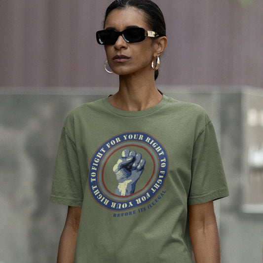 Person wearing a khaki t-shirt with a graphic design and sunglasses. A civil rights t-shirt reminding us not to take our freedom for granted. Fight for your right to demonstrate before it's made illegal. Made from 100% organic ring-spun cotton, this anti-establishment t-shirt is unisex, high-quality, super comfy, and best of all, eco-friendly.