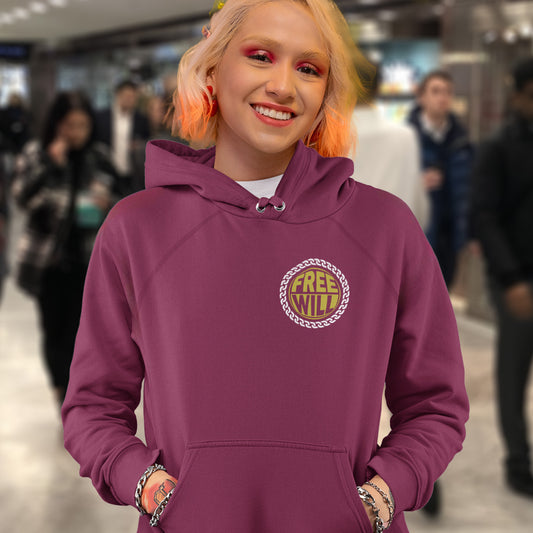 Person wearing a burgundy hoodie with 'Free Will' logo in a blurred indoor setting. A civil rights hoodie design to promote independent thought and self awareness. If you are feeling overwhelmed by influence, join the 'free will' movement. Comfortable and practical. It's extra soft and has a convenient front pouch pocket. Made from organic cotton and recycled polyester, this social awareness hoodie is a great eco-friendly choice.