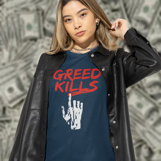 A woman standing in front of a backdrop of money, playing with her hair and wearing a French navy blue crew neck t-shirt with a hand writing "GREED KILLS" in blood red.