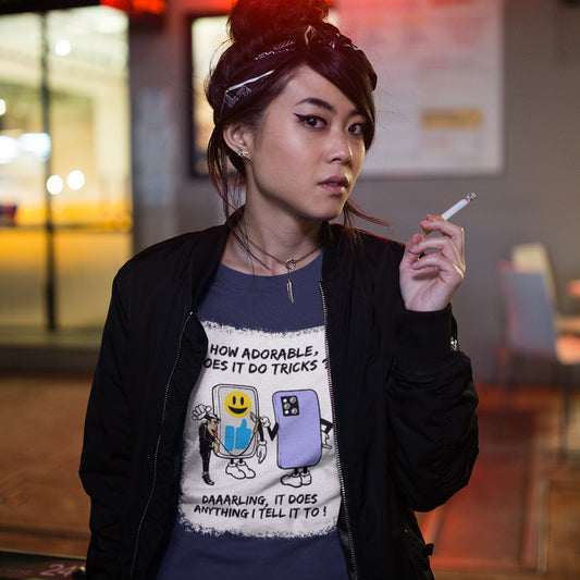 Person wearing a graphic t-shirt with text and images, holding a cigarette outdoors. An anti mobile phone abuse t-shirt depicting a twisted view of what's really going on in some peoples relationship with their mobile phone. Sometimes you have to wonder who owns who. An original design to promote social awareness. Made from 100% organic ring-spun cotton, this anti smart phone abuse t-shirt is unisex, high-quality, super comfy, and best of all, eco-friendly.