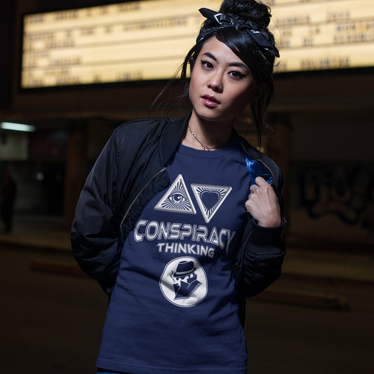 Person wearing a French navy blue shirt with conspiracy theory symbols and text. A cryptic conspiracy theory t-shirt design for all of those conspiracy theory lovers out there who know it's more than a theory, it's a way of life. From Alien advocates or bigfoot believers to Cabal conspiracy theorists, an original design for all. Made from 100% organic ring-spun cotton, this conspiracy theory t-shirt is unisex, high-quality, super comfy, and best of all, eco-friendly.