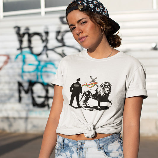 A woman wearing a baseball cap backwards standing in the street, wearing a white short sleeved crew neck t-shirt with a graffiti stencil design of a security guard checking the underside of the Lion of Judah for explosives.