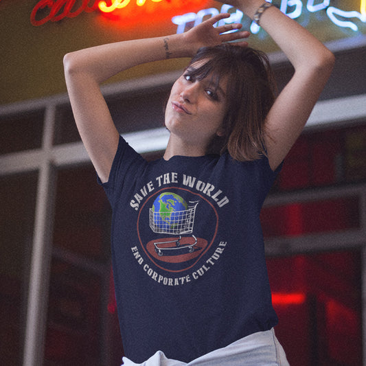 A woman with her arms raised wears a navy blue graphic t-shirt featuring a globe and shopping cart design with the text 'SAVE THE WORLD' and 'END CORPORATE CULTURE'. The background shows a dimly lit, neon-lit environment.