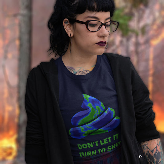 Person wearing a black t-shirt with a graphic design and text, standing against a fiery background. A funny environmental t-shirt suggesting If we don't do something about our effect on the planet soon it'll all turn to shit. Save the planet satire. Made from 100% organic ring-spun cotton, this 'save our planet' t-shirt is unisex, high-quality, super comfy, and best of all, eco-friendly.