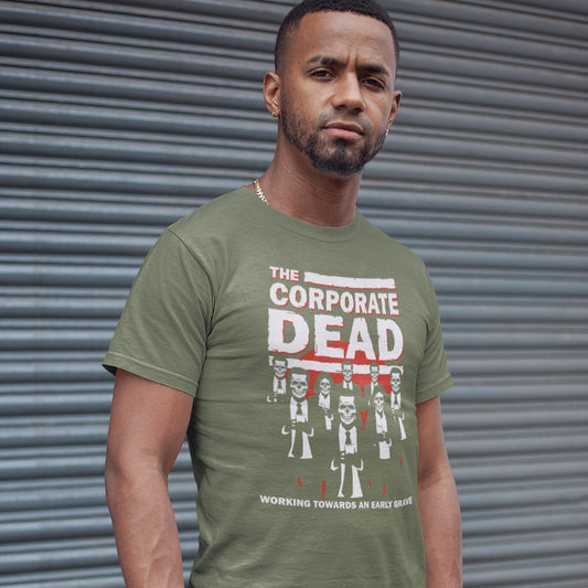 Man standing against a garage door wearing a khaki 'Corporate Dead' t shirt. A satirical anti corporate t shirt in an old horror movie design suggesting that working for a corporation is a soulless task. they can be faster and more efficient than a regular zombie, but dead inside nonetheless. Made from 100% organic ring-spun cotton, this non conformist t shirt is unisex, high-quality, super comfy, and best of all, eco-friendly.