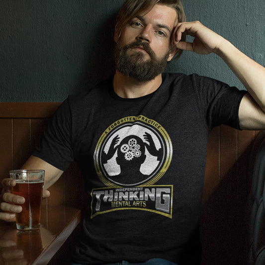 Man wearing a black t-shirt with a graphic design, holding a glass of beer. A sign of the times t shirt suggesting independent thinking is a forgotten art since we let machines think for us. Promote independent thinking with this some what sarcastic t-shirt. Made from 100% organic ring-spun cotton, this urban art t shirt is unisex, high-quality, super comfy, and best of all, eco-friendly.