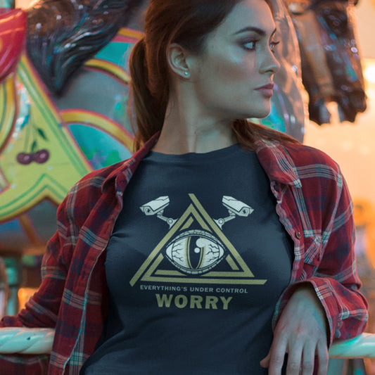 Woman wearing a t-shirt with a graphic design and text, standing in front of a colourful carousel. A conspiracy theory t-shirt for all that see paranoia as a necessity. This design is a must if your imagination is colourful enough to believe we are being controlled by reptilian alien overlords. Made from 100% organic ring-spun cotton, this alien conspiracy theory t-shirt is unisex, high-quality, super comfy, and best of all, eco-friendly.