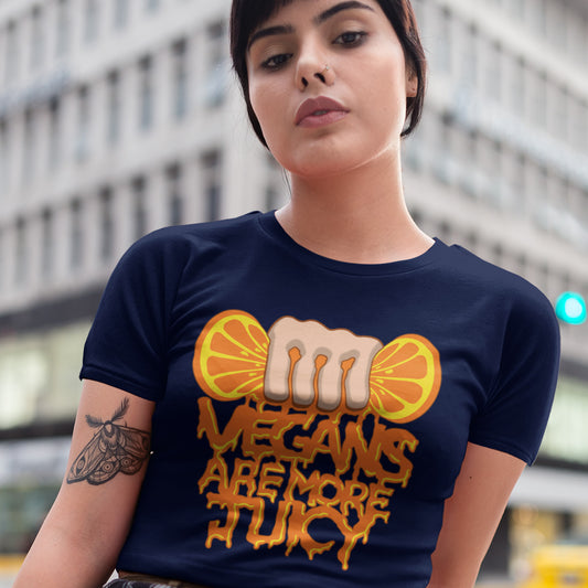 Person wearing a French navy blue t-shirt with a graphic design and text. A plant based meat free t shirt design suggesting vegans drink more juices than most. Made from 100% organic ring-spun cotton, this vegan dairy free t shirt is unisex, high-quality, super comfy, and best of all, eco-friendly.
