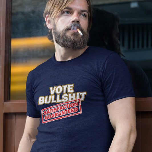 Man wearing a French navy blue t-shirt with a humorous graphic design, sitting outdoors. This political t-shirt design tells it like it is. This unique anti-establishment t-shirt is for those who have lost all faith in politics. It seems no matter what you vote for, you definitely get bullshit. Made from 100% organic ring-spun cotton, this anti-government t-shirt is unisex, high-quality, super comfy, and best of all, eco-friendly.