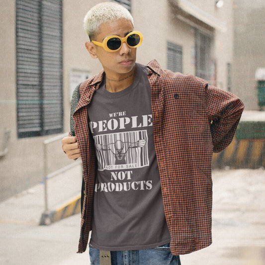 Person wearing yellow sunglasses and wearing a t shirt with 'we're people not products' text. An anti capitalism t shirt highlighting the dehumanisation of people in a money obsessed society. A fantastic choice for any anti capitalism protest or to just create social awareness. Made from 100% organic ring-spun cotton, this anti consumerism t shit is unisex, high-quality, super comfy, and best of all, eco-friendly.