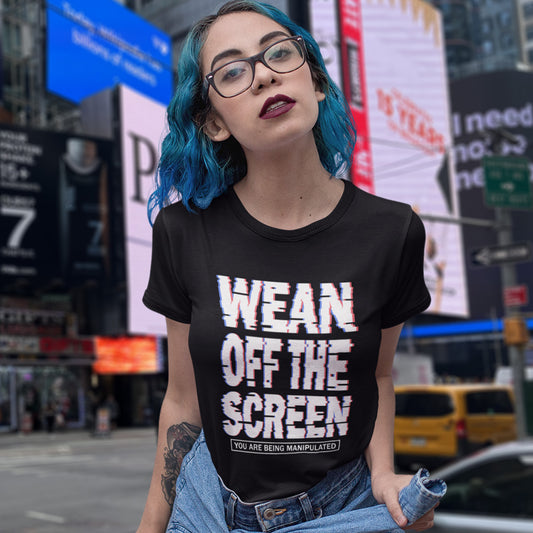 Person wearing a black t-shirt with text in Times Square, New York City. This media based conspiracy theory t-shirt suggests there is more to digital media and entertainment than meets the eye. An anti mobile abuse slogan in a unique design to increase social awareness of too much screen time. Made from 100% organic ring-spun cotton, this conspiracy theory t-shirt is unisex, high-quality, super comfy, and best of all, eco-friendly.