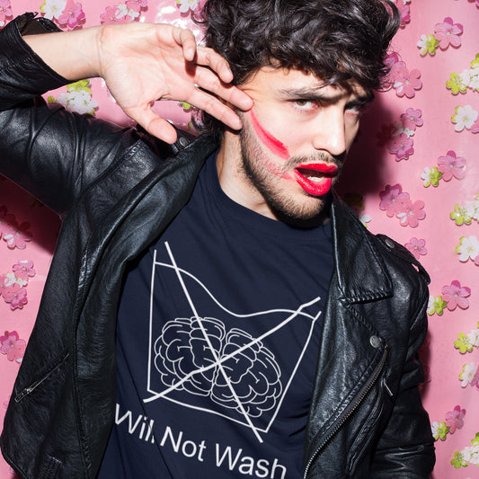 Man wearing a black leather jacket and a black t-shirt with a graphic design, posing against a pink floral background. A self worth t shirt promoting a strong mind and a resistance to brainwashing. this unique anti-establishment t-shirt design is a play on washing instructions and highlights the mass influence and indoctrination in modern society. Made from 100% organic ring-spun cotton, this clever slogan t shirt is unisex, high-quality, super comfy, and best of all, eco-friendly.