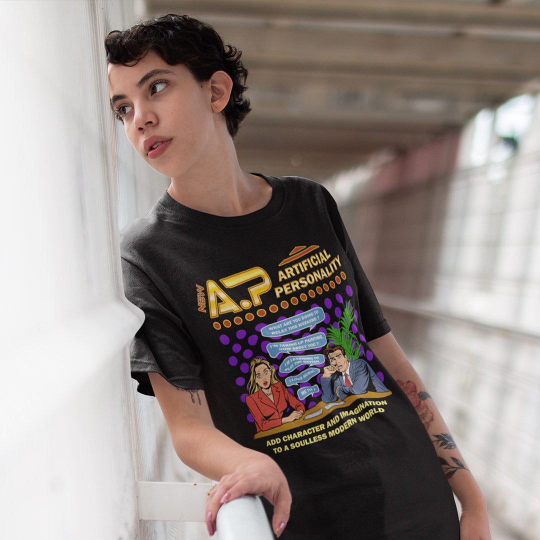 Person wearing a black t-shirt with colourful graphics and text. This anti ai t shirt design, in a comic book pop art style, warns against artificial intelligence taking over too many aspects of our lives. In an ever increasing dependency on artificial realities, just how far will it go ? Will our personalities be artificial one day ? Satirical and sarcastic, funny but scary. Made from 100% organic ring-spun cotton, this anti ai t shirt is unisex, high-quality, super comfy, and best of all, eco-friendly.