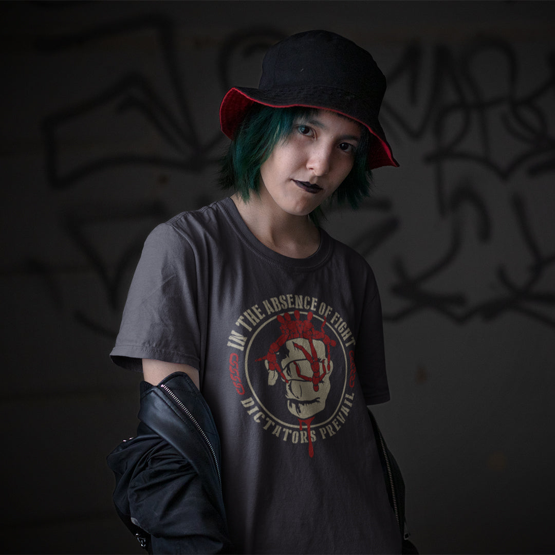 Person wearing a dark t-shirt with graphic design and text, standing against a dark background. This social issues t shirt plays on the saying 'In the absence of light, darkness prevails' with a political message encouraging people to put their apathy and denial aside and fight for their rights before they are taken advantage of. Made from 100% organic ring-spun cotton, this human rights t shirt is unisex, high-quality, super comfy, and best of all, eco-friendly.