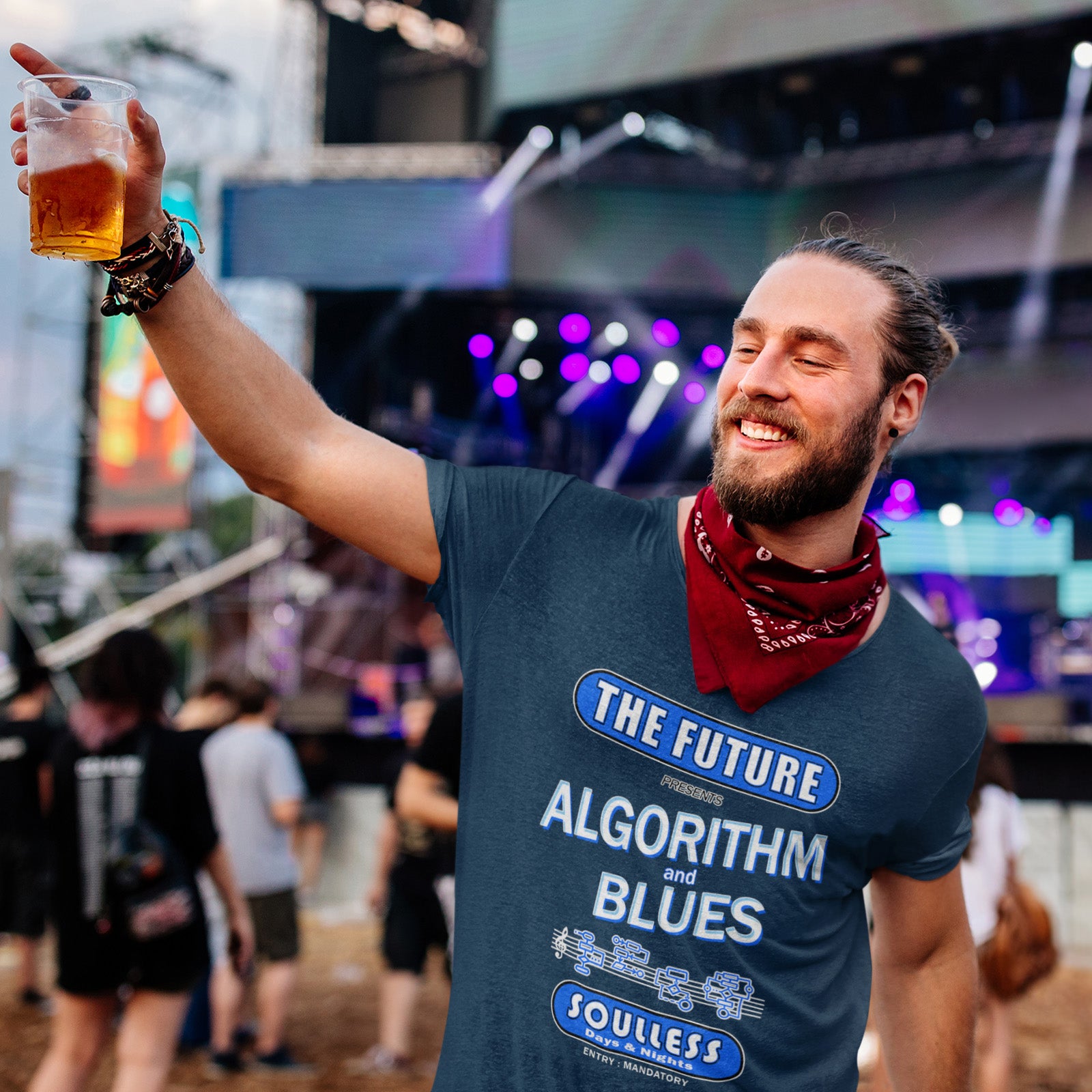 Man at a music festival wearing a t-shirt with text, holding a drink. This sign of the times t shirt design is a play on an old music poster and an alternative view of what the future may hold in a world that is decided on algorithms. Made from 100% organic ring-spun cotton, this social awareness t shirt is unisex, high-quality, super comfy, and best of all, eco-friendly.
