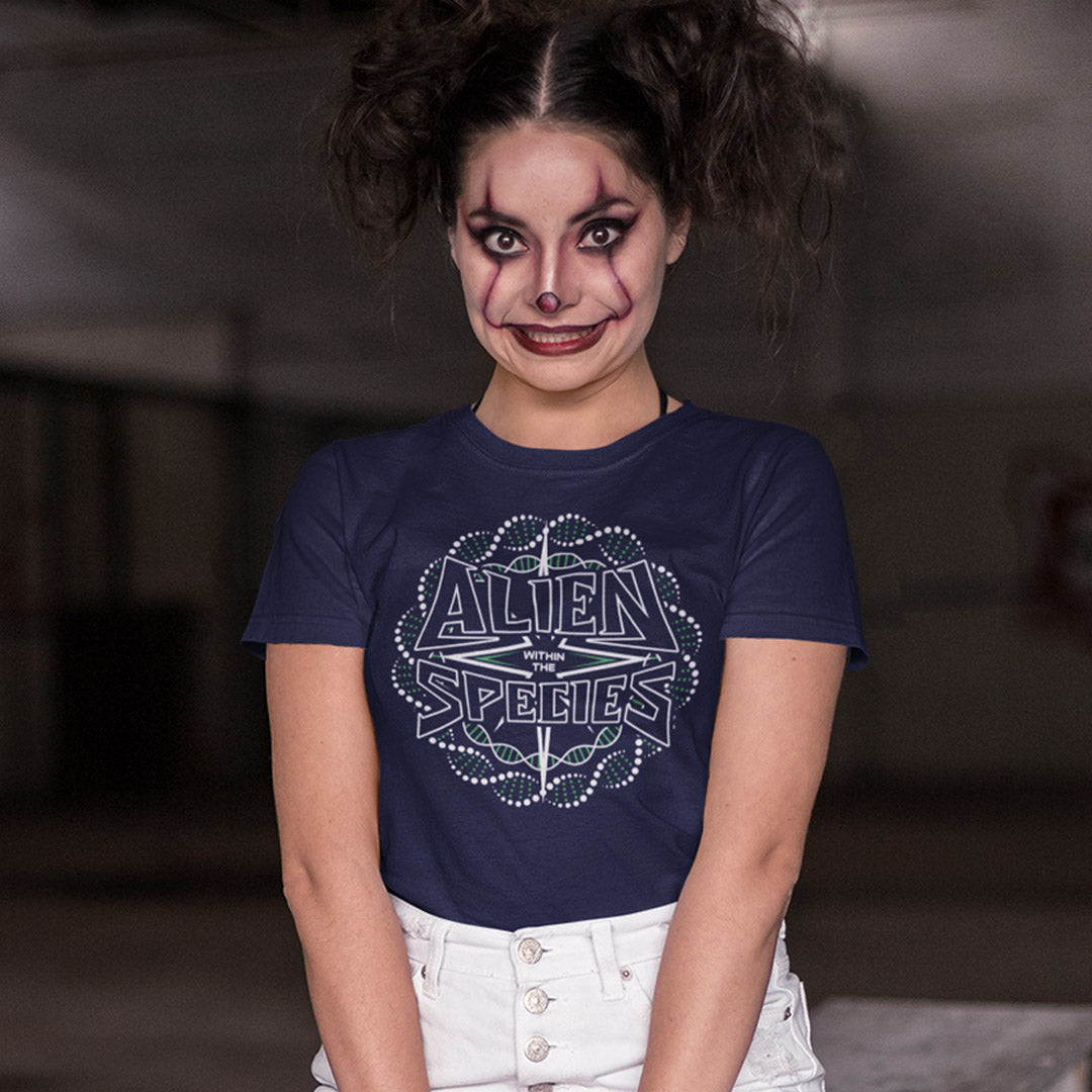 Person wearing a navy blue t-shirt with 'Alien Species' design, posing against a blurred background. This non conformist t shirt expands the use of the word 'Alien'. This design is ideal for everyone that feels they don't truly relate to the rest of humankind and modern society. Made from 100% organic ring-spun cotton, this counter culture t-shirt is unisex, high-quality, super comfy, and best of all, eco-friendly.