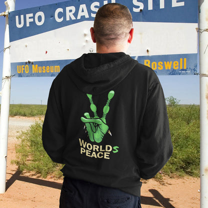 Person wearing a black hoodie with a green peace symbol and 'Worlds Peace' text, standing in front of a Roswell UFO Museum sign. A world peace hoodie with an alien lovers twist. When we think of world peace lets not be selfish about it., lets include all Worlds. Comfortable and practical. It's extra soft and has a convenient front pouch pocket. Made from organic cotton and recycled polyester, this unique alien hoodie is the perfect eco-friendly choice.