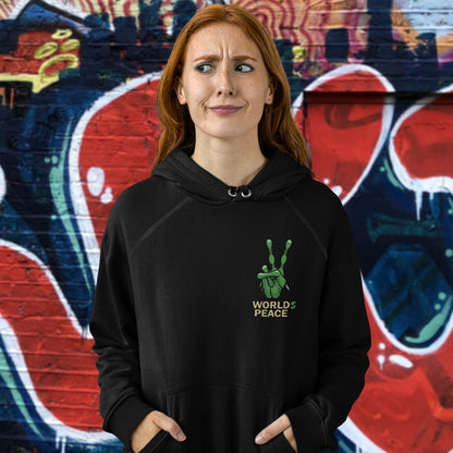 Person wearing a black hoodie with 'World Peace' text in front of a colourful mural. A world peace hoodie with an alien lovers twist. When we think of world peace lets not be selfish about it., lets include all Worlds. Comfortable and practical. It's extra soft and has a convenient front pouch pocket. Made from organic cotton and recycled polyester, this unique alien hoodie is the perfect eco-friendly choice.