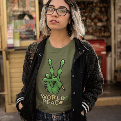 Person wearing a green 'World Peace' t-shirt in an urban setting. A world peace t shirt with an alien lovers twist. When we think of world peace lets not be selfish about it., lets include all Worlds. Made from 100% organic ring-spun cotton, this funny alien t shirt is unisex, high-quality, super comfy, and best of all, eco-friendly.