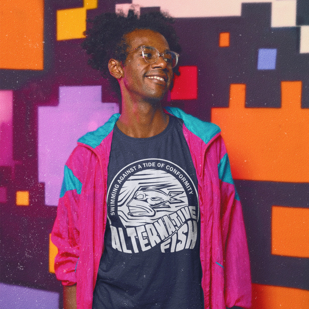 Person wearing a pink jacket and graphic t-shirt against a colourful geometric background. A non conformist t shirt for all who think outside the box. Don't just be another fish in the sea. Push back the tide of conformity with this anti establishment t shirt design. Made from 100% organic ring-spun cotton, this counter culture t shirt is unisex, high-quality, super comfy, and best of all, eco-friendly.