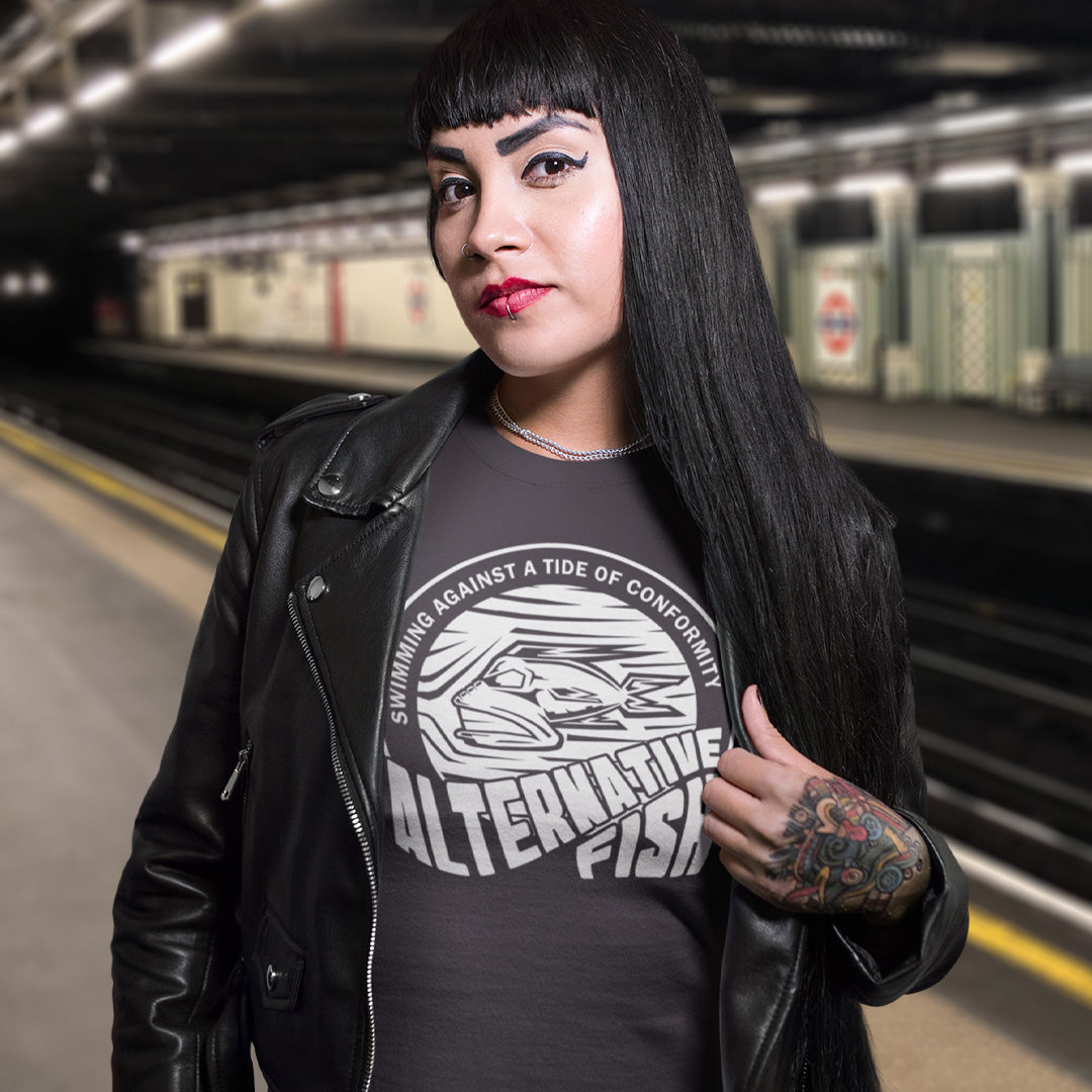 Woman wearing a black leather jacket and graphic t-shirt in a subway station. A non conformist t shirt for all who think outside the box. Don't just be another fish in the sea. Push back the tide of conformity with this anti establishment t shirt design. Made from 100% organic ring-spun cotton, this counter culture t shirt is unisex, high-quality, super comfy, and best of all, eco-friendly.