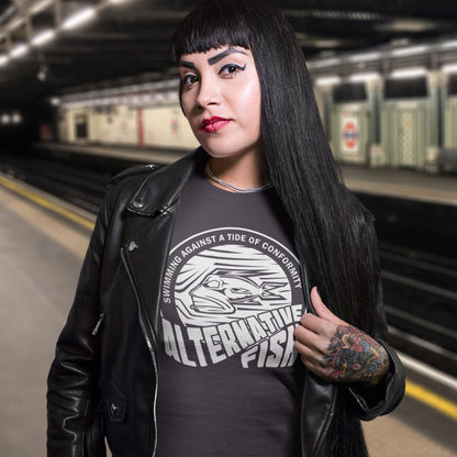 Woman wearing a black leather jacket and graphic t-shirt in a subway station. A non conformist t shirt for all who think outside the box. Don't just be another fish in the sea. Push back the tide of conformity with this anti establishment t shirt design. Made from 100% organic ring-spun cotton, this counter culture t shirt is unisex, high-quality, super comfy, and best of all, eco-friendly.