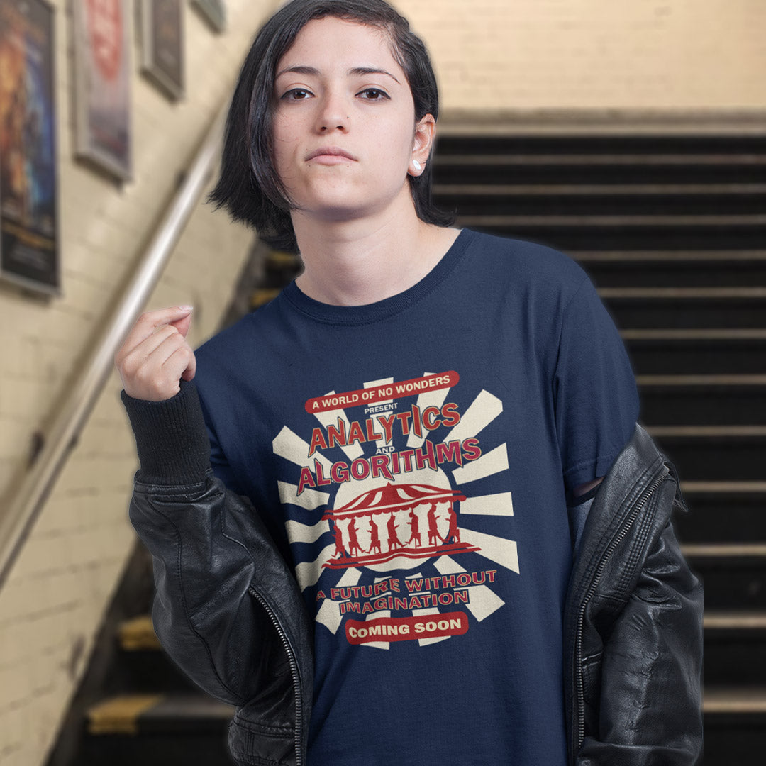 Woman in a stair way wearing a French navy blue t-shirt with an "AVALYTICS AND ALGORITHMS" spoof fairground poster design.