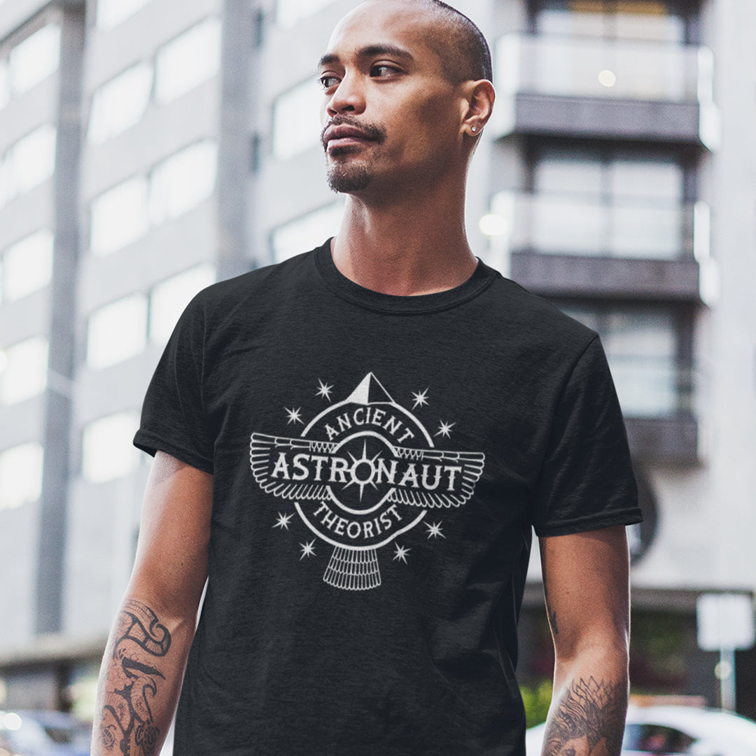 Man standing outside wearing a black t-shirt with "ANCIENT ASTRONAUT THEORIST" logo.