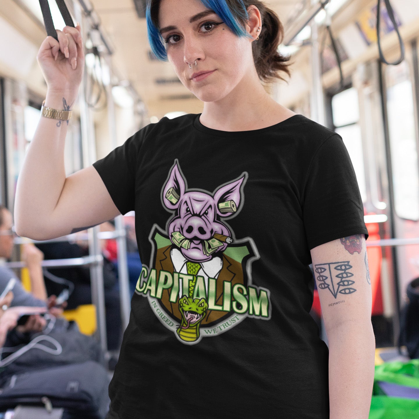 Person wearing a black t-shirt with a graphic design on a bus.