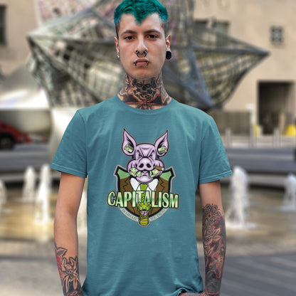 Person wearing a teal t-shirt with a pig graphic and 'CAPITALISM' text, standing in an outdoor setting.