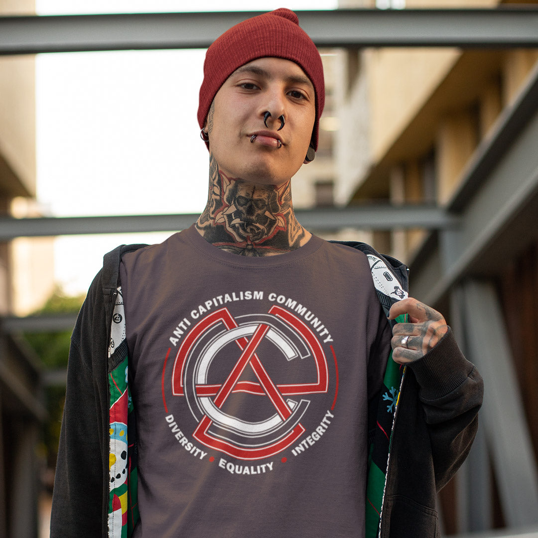 Person wearing a t-shirt with an anti-capitalism design outdoors. This anti establishment t shirt speaks out against capitalism and promotes diversity, equality and integrity. Capitalism is responsible for so many of societies problems, do not accept it. Join our community and be proud to wear the shirt. Made from 100% organic ring-spun cotton, this anti capitalist t shirt is unisex, high-quality, super comfy, and best of all, eco-friendly.