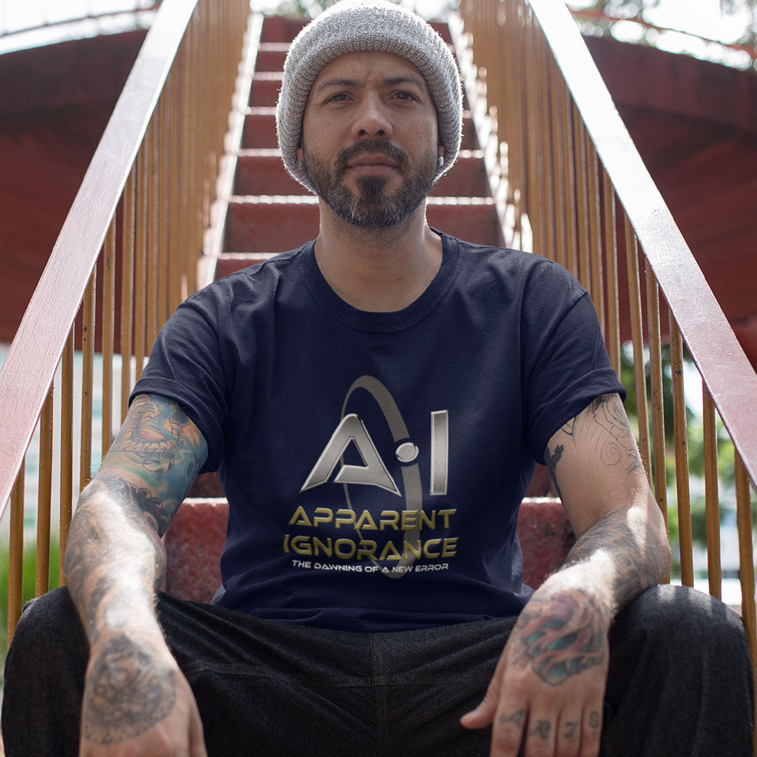 A man wearing a grey knit beanie and a navy blue graphic t-shirt sitting on outdoor wooden stairs. The t-shirt features a metallic silver 'A.I.