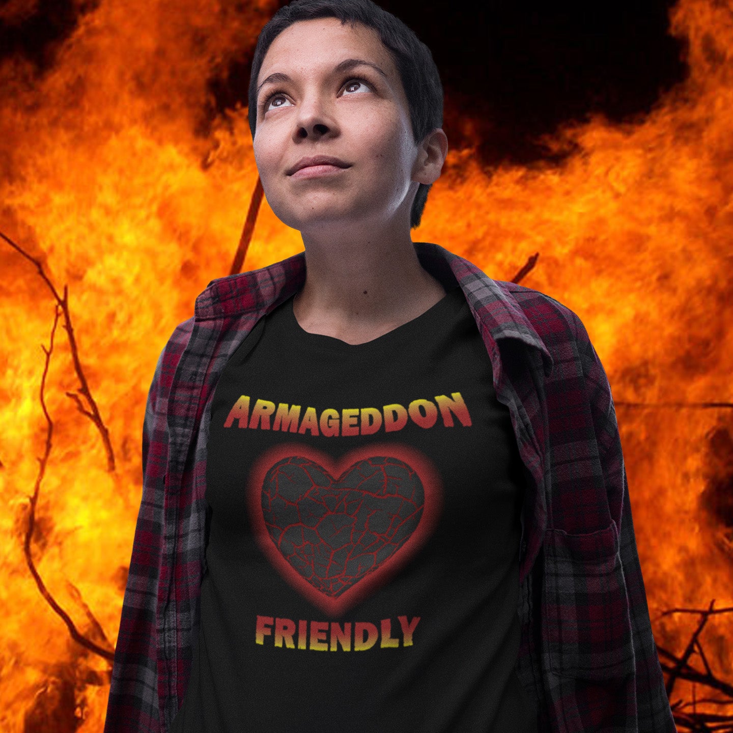 Person wearing a black t-shirt with 'Armageddon Friendly' design against a fiery background. A non conformist t shirt design for the pessimist among us. If you find yourself losing faith in humankind, and feel your heart turning to stone, get it out of your system with this alternative counterculture design. Great for anyone who thinks outside the box. Made from 100% organic ring-spun cotton, this social awareness t shirt is unisex, high-quality, super comfy, and best of all, eco-friendly.