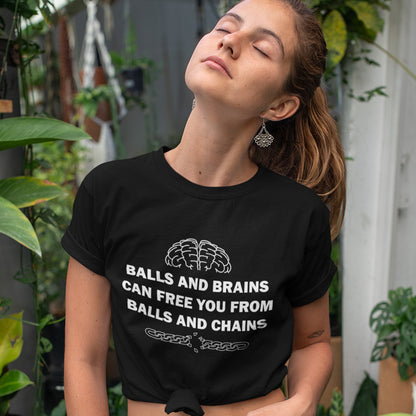 Woman wearing a black t-shirt with text and graphic design, standing outdoors with plants in the background. A civil liberties t shirt limerick to remind you of what it takes to free yourself, metaphorically speaking. Made from 100% organic ring-spun cotton, this self worth t shirt is unisex, high-quality, super comfy, and best of all, eco-friendly.