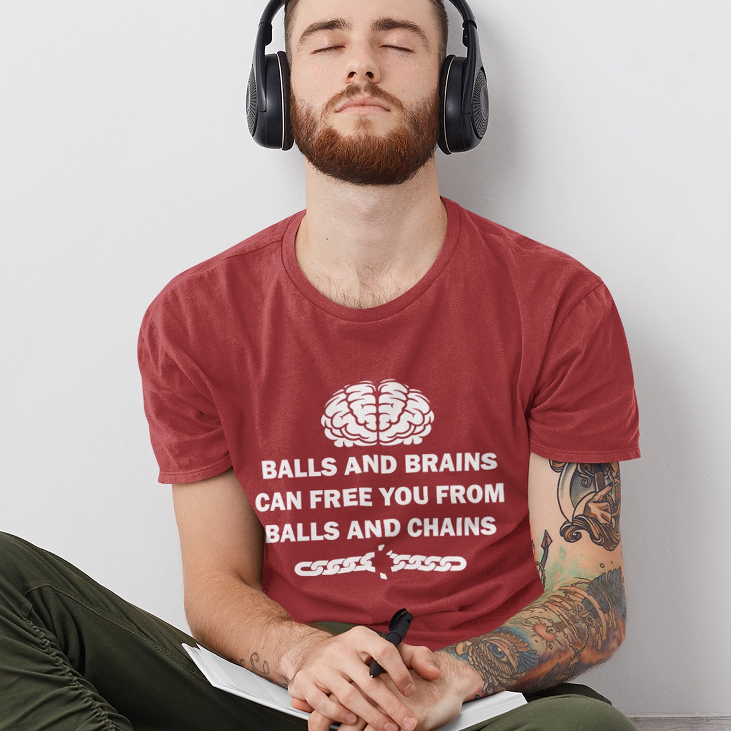 Man wearing a burgundy t-shirt with a brain graphic and text, sitting against a plain background. A civil liberties t shirt limerick to remind you of what it takes to free yourself, metaphorically speaking. Made from 100% organic ring-spun cotton, this self worth t shirt is unisex, high-quality, super comfy, and best of all, eco-friendly.