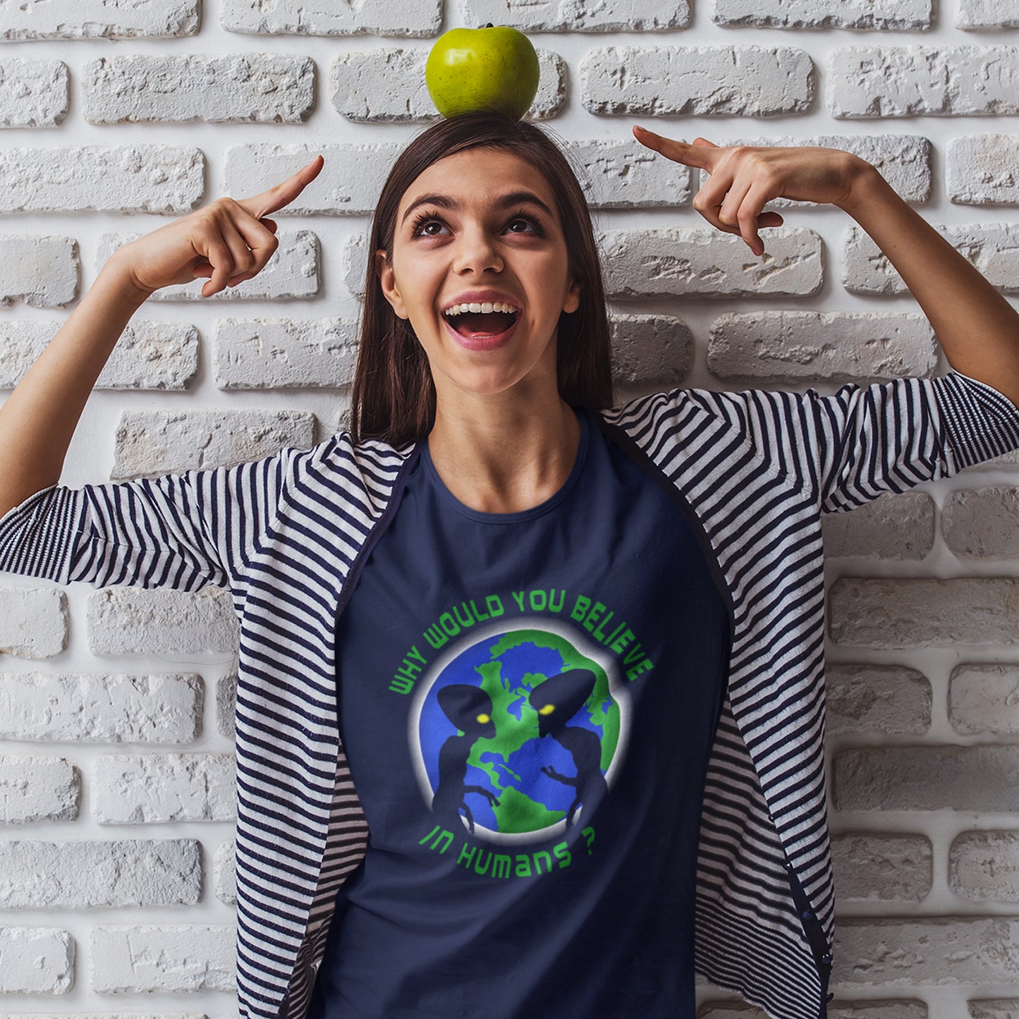 Woman wearing a t-shirt with a graphic design, standing against a white brick wall. A funny UFO t-shirt with a play on words design. We question whether or not to believe in aliens but with so much evidence around is it not a more important question to wonder if they have lost their faith in us . Made from 100% organic ring-spun cotton, this conspiracy theorist t-shirt is unisex, high-quality, super comfy, and best of all, eco-friendly.