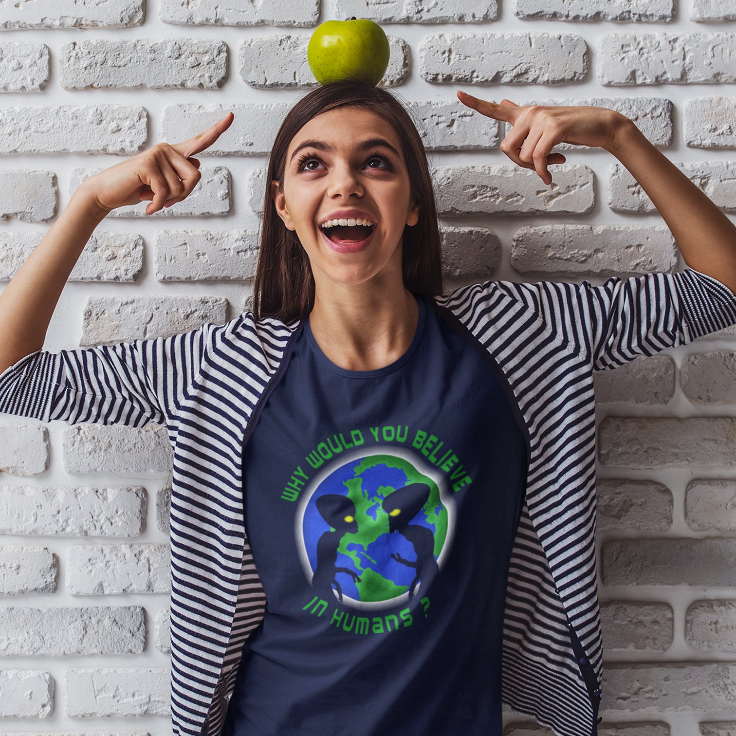 Woman wearing a t-shirt with a graphic design, standing against a white brick wall. A funny conspiracy theory t shirt with a play on words design. We question whether or not to believe in aliens but with so much evidence around is it not a more important question to wonder if they have lost their faith in us. Made from 100% organic ring-spun cotton, this conspiracy theorist t shirt is unisex, high-quality, super comfy, and best of all, eco-friendly.
