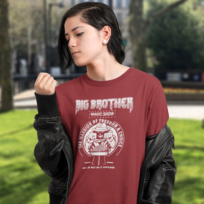 Person wearing a burgundy sweatshirt with 'Big Brother' graphic design outdoors. A funny conspiracy theory t-shirt suggesting our 'freedom of choice' is just part of an elaborate illusion. Magic shows are great until you realise you are living in one. This witty unique design hints at our society being distracted by greed. Made from 100% organic ring-spun cotton, this witty conspiracy theory t-shirt is unisex, high-quality, super comfy, and best of all, eco-friendly.