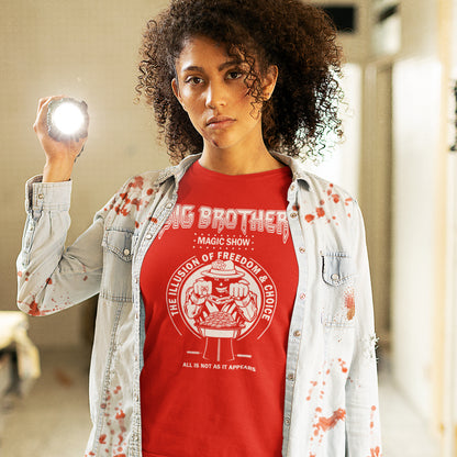 Person wearing a red 'Big Brother' t-shirt with a graphic design, holding a light source. A funny conspiracy theory t-shirt suggesting our 'freedom of choice' is just part of an elaborate illusion. Magic shows are great until you realise you are living in one. This witty unique design hints at our society being distracted by greed. Made from 100% organic ring-spun cotton, this witty conspiracy theory t-shirt is unisex, high-quality, super comfy, and best of all, eco-friendly.
