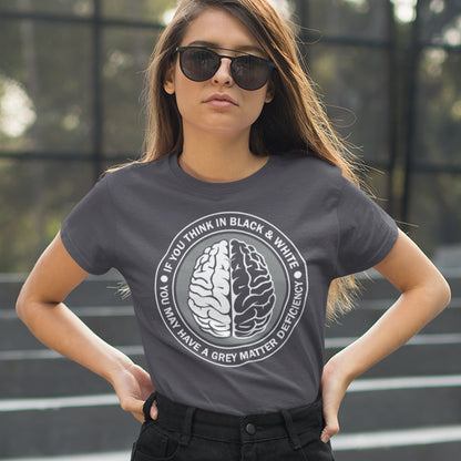 Person wearing an anthracite t-shirt with a brain graphic and text outdoors. A stencil art t shirt design. It would be so easy if life was black and white, but it's the grey area where all the thinking and personal growth is done. A philosophy t shirt design for people who see the detail and can think outside the box. Made from 100% organic ring-spun cotton, this social awareness t shirt is unisex, high-quality, super comfy, and best of all, eco-friendly.