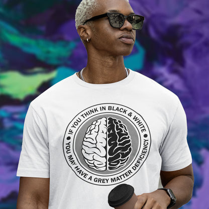 Person wearing a white t-shirt with a brain graphic and text, standing against a colourful abstract background. A stencil art t shirt design. It would be so easy if life was black and white, but it's the grey area where all the thinking and personal growth is done. A philosophy t shirt design for people who see the detail and can think outside the box. Made from 100% organic ring-spun cotton, this social awareness t shirt is unisex, high-quality, super comfy, and best of all, eco-friendly.