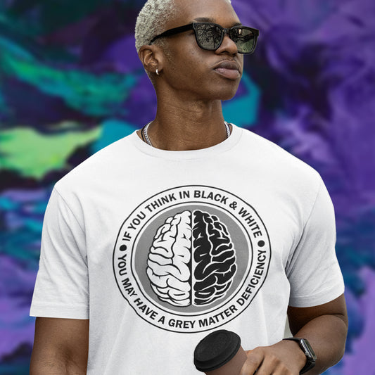 Person wearing a white t-shirt with a brain graphic and text, standing against a colourful abstract background. A stencil art t shirt design. It would be so easy if life was black and white, but it's the grey area where all the thinking and personal growth is done. A philosophy t shirt design for people who see the detail and can think outside the box. Made from 100% organic ring-spun cotton, this social awareness t shirt is unisex, high-quality, super comfy, and best of all, eco-friendly.