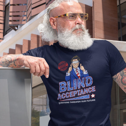 Man wearing a navy blue t-shirt with a graphic design and text, standing outdoors. A funny election t shirt design in a mock campaign poster style. This satirical urban art design suggests that the preferred approach to politics any government would want from their citizens is one of blind acceptance, or is this already happening ? Made from 100% organic ring-spun cotton, this anti government t shirt is unisex, high-quality, super comfy, and best of all, eco-friendly.