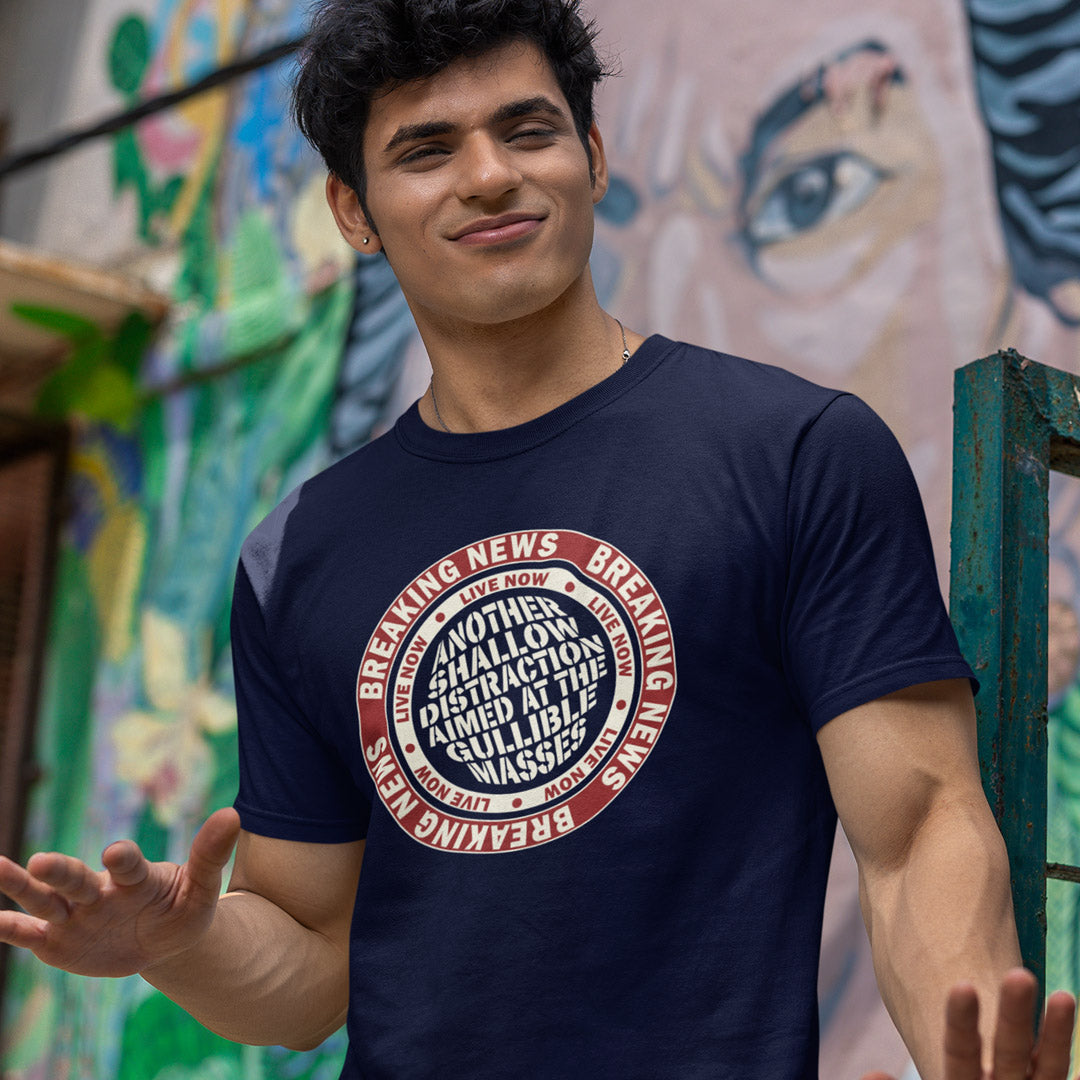Man standing outside wearing a French navy t shirt. An anti media, non conformist t shirt. This design suggests that the media is being used to keep us distracted from the real issues taking place around us. Don't fall for the new bright flashing lights! Made from 100% organic ring-spun cotton, this social awareness t shirt is unisex, high-quality, super comfy, and best of all, eco-friendly.