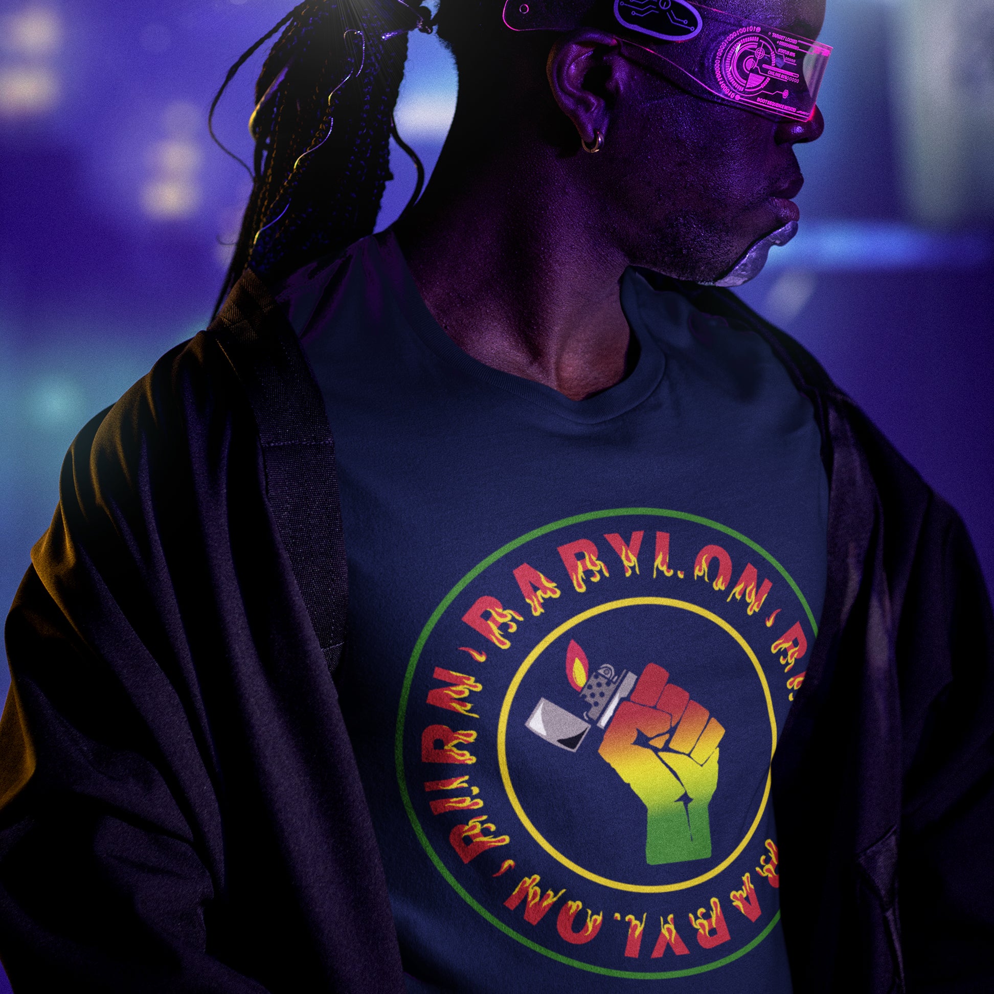 Person wearing a dark blue t-shirt with a colourful graphic and text, set against a purple and blue gradient background. A Rastafarian civil rights t shirt. Babylon is the symbol of corruption and decadence. Take a leaf out of the Rastafarian book with this 'power to the people' anti government t-shirt. Made from 100% organic ring-spun cotton, this urban art t shirt is unisex, high-quality, super comfy, and best of all, eco-friendly.