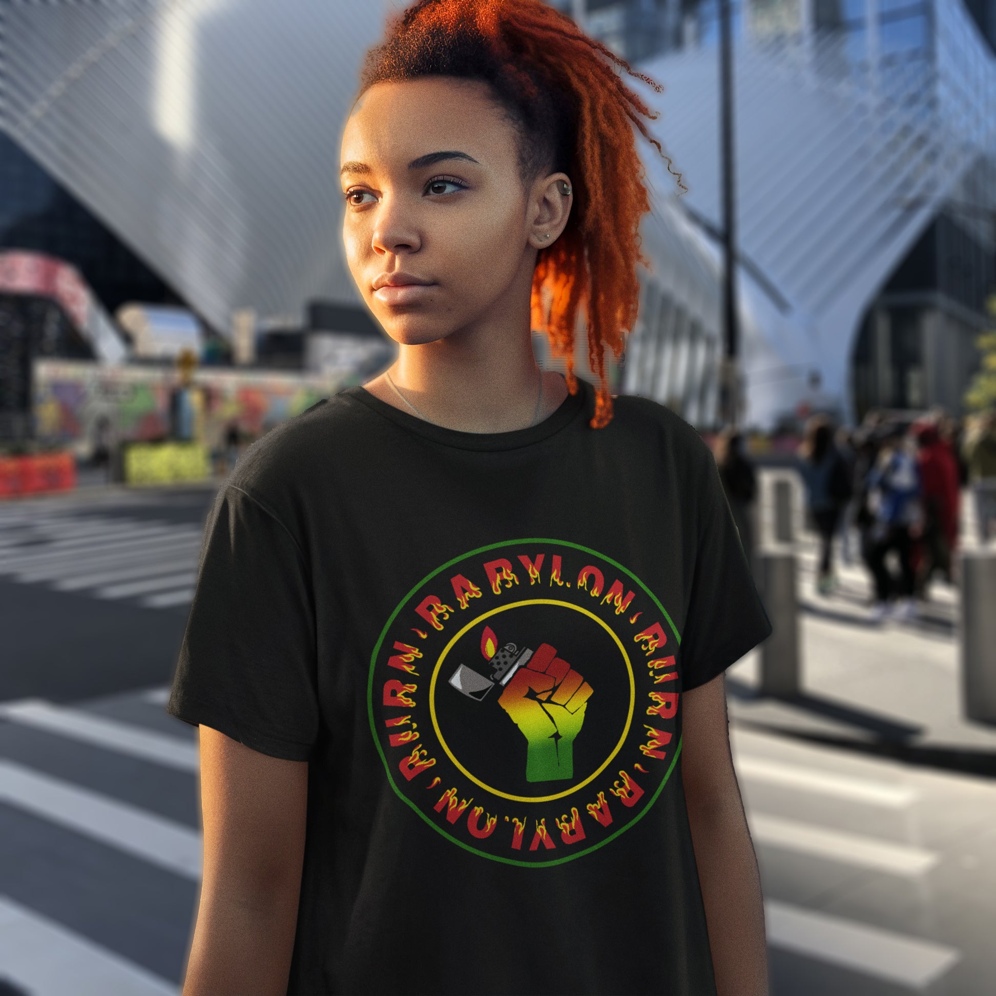 Person wearing a black t-shirt with a colourful graphic design on a city street. A Rastafarian civil rights t shirt. Babylon is the symbol of corruption and decadence. Take a leaf out of the Rastafarian book with this 'power to the people' anti government t-shirt. Made from 100% organic ring-spun cotton, this urban art t shirt is unisex, high-quality, super comfy, and best of all, eco-friendly.