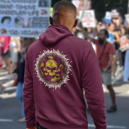 Person wearing a burgundy hoodie with a skull design at a protest event. This environmental hoodie is concerned with global warming. A design to keep climate issues at the forefront of peoples minds. A burning issue. Made from 100% organic ring-spun cotton, this environmental awareness hoodie is unisex, high-quality, super comfy, and best of all, eco-friendly.